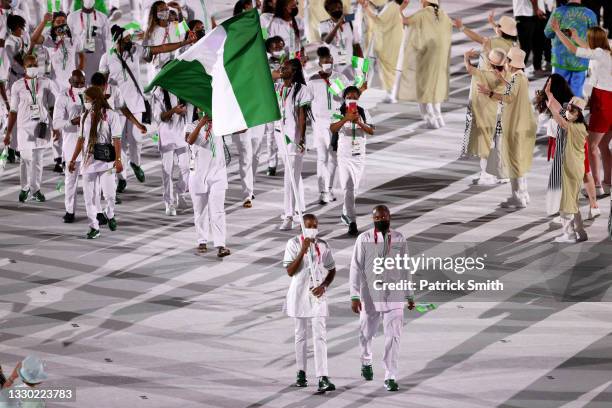 Flag bearers Roukaya Moussa Mahamane and Abdoul Razak Issoufou Alfaga of Team Nigeria lead their team during the Opening Ceremony of the Tokyo 2020...