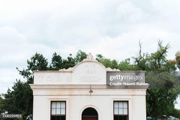 historic town hall building facade in front of a tree - country town australia stock pictures, royalty-free photos & images