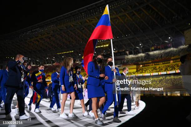 Flag bearers Karen Leon and Antonio Jose Diaz Fernandez of Team Venezuela lead their team out during the Opening Ceremony of the Tokyo 2020 Olympic...