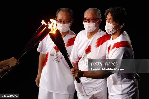 Shigeo Nagashima, Hideki Matsui and Sadaharu Oh carry the olympic flame during the Opening Ceremony of the Tokyo 2020 Olympic Games at Olympic...