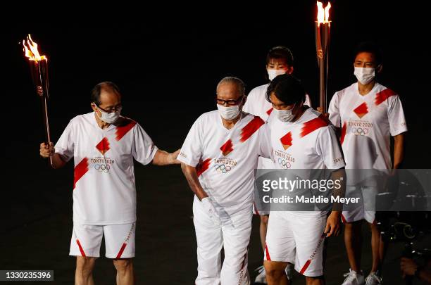 Shigeo Nagashima, Hideki Matsui and Sadaharu Oh carry the olympic flame during the Opening Ceremony of the Tokyo 2020 Olympic Games at Olympic...