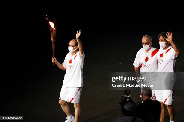 Shigeo Nagashima, Hideki Matsui and Sadaharu Oh carry the olympic flame during the Opening Ceremony of the Tokyo 2020 Olympic Games at Olympic...