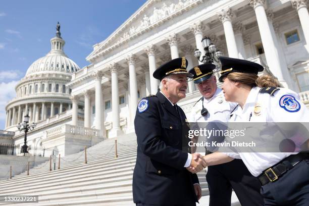 Incoming U.S. Capitol Police Chief J. Thomas Manger greets officers after being sworn-in during a ceremony outside of the U.S. Capitol on July 23,...