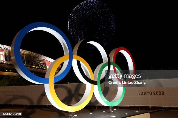 Drone display is seen over the top of the Olympic Rings outside the stadium during the Opening Ceremony of the Tokyo 2020 Olympic Games at Olympic...