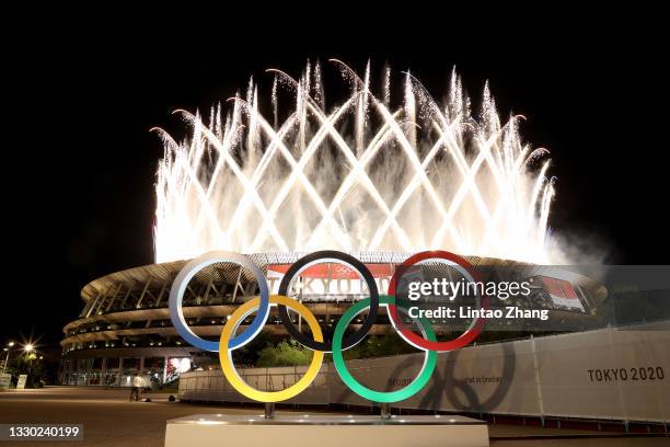 The Olympic Rings are seen outside the stadium as fireworks go off during the Opening Ceremony of the Tokyo 2020 Olympic Games at Olympic Stadium on...