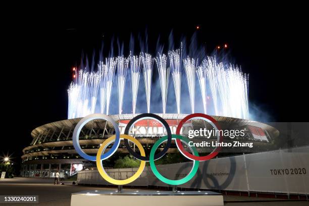 The Olympic Rings are seen outside the stadium as fireworks go off during the Opening Ceremony of the Tokyo 2020 Olympic Games at Olympic Stadium on...