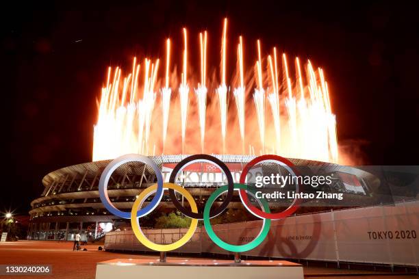 The Olympic Rings are seen outside the stadium as fireworks go off during the Opening Ceremony of the Tokyo 2020 Olympic Games at Olympic Stadium on...