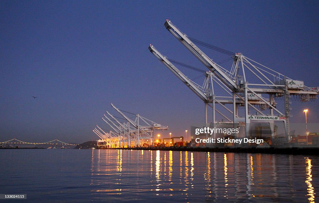 Container cranes in Port of Oakland dawn Estuary