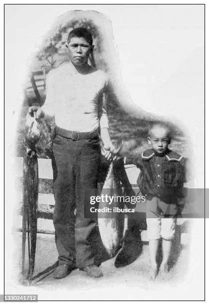 antique black and white photograph: japanese fisherman and his son, hawaii - hawaiian ethnicity stock illustrations