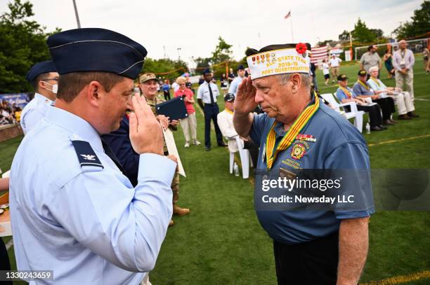 Col. Jeffery D. Cannet, left, salutes Arthur Krumm, of Massapequa Park, New York, after presenting him a medal as the Long Island Air Force...