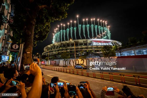 People take photographs of fireworks during the Opening Ceremony of the Tokyo 2020 Olympic Games at Olympic Stadium on July 23, 2021 in Tokyo, Japan.
