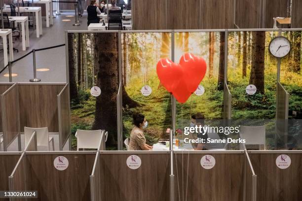 People enjoy a blind date in the waiting area of the vaccine centre during the 'Sjansen with Janssen' event on July 23, 2021 in Haarlem, Netherlands....