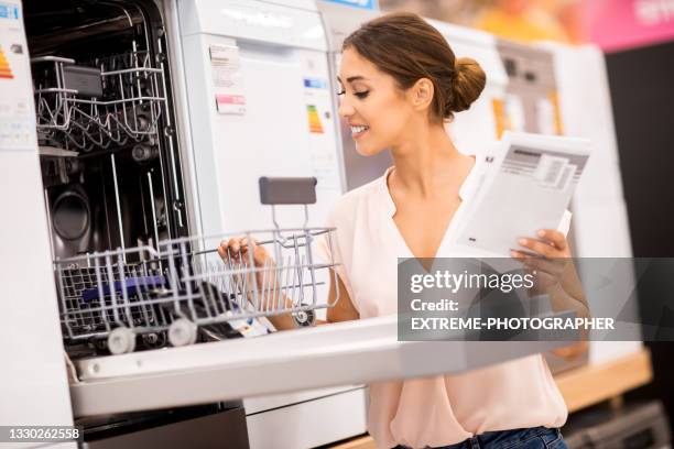 lächelnde einkäuferin kauft waren für ihr neues haus ein - küchenzubehör stock-fotos und bilder
