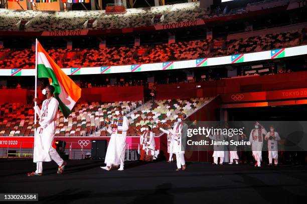 Flag bearer Abdoul Razak Issoufou Alfaga of Team Niger leads his team out during the Opening Ceremony of the Tokyo 2020 Olympic Games at Olympic...