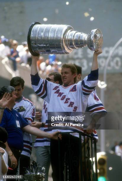 Brian Leetch of the New York Rangers holds the Stanley Cup Trophy during the Rangers Stanley Cup Ticker Tape Parade on June 17, 1994 after defeating...