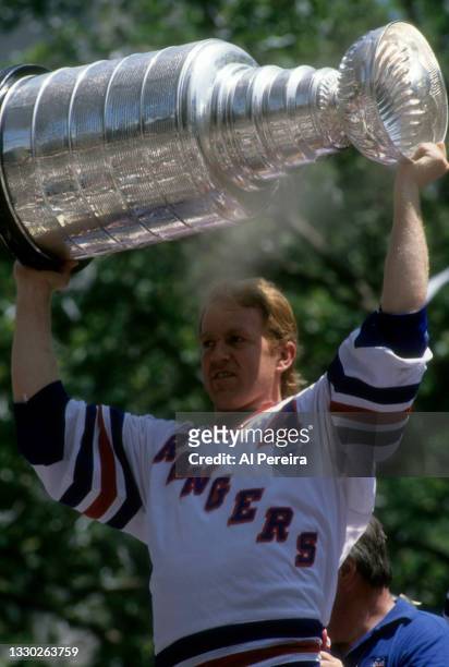 Brian Leetch of the New York Rangers holds the Stanley Cup Trophy during the Rangers Stanley Cup Ticker Tape Parade on June 17, 1994 after defeating...