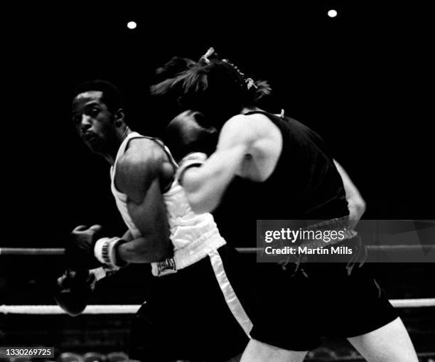 Amateur boxer Bobby Lee Hunter of the United States punches amateur boxer Gary Griffin of the United States during their light flyweight match on...