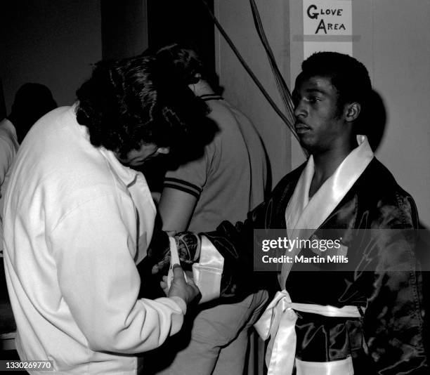 Amateur boxer Bobby Lee Hunter of the United States gets his gloves checked before his light flyweight match against amateur boxer Gary Griffin of...