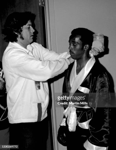 Amateur boxer Bobby Lee Hunter of the United States gets lathered up with Vaseline before his light flyweight match against amateur boxer Gary...