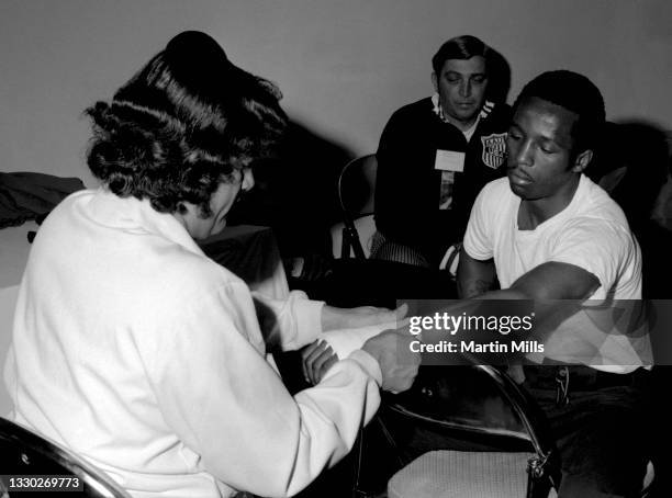 Amateur boxer Bobby Lee Hunter of the United States gets taped up before his light flyweight match against amateur boxer Gary Griffin of the United...