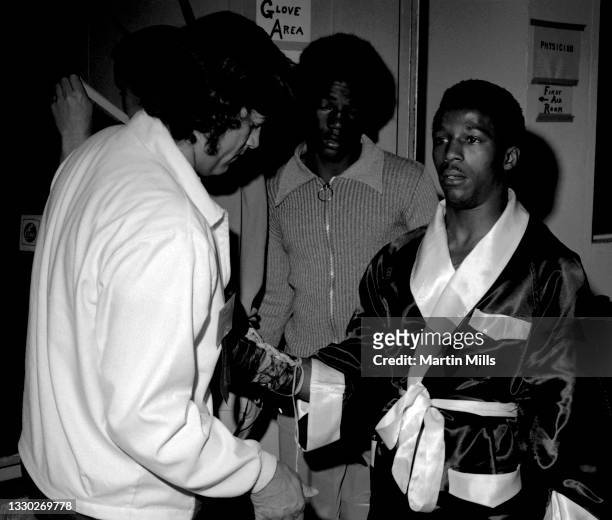 Amateur boxer Bobby Lee Hunter of the United States gets his gloves checked before his light flyweight match against amateur boxer Gary Griffin of...