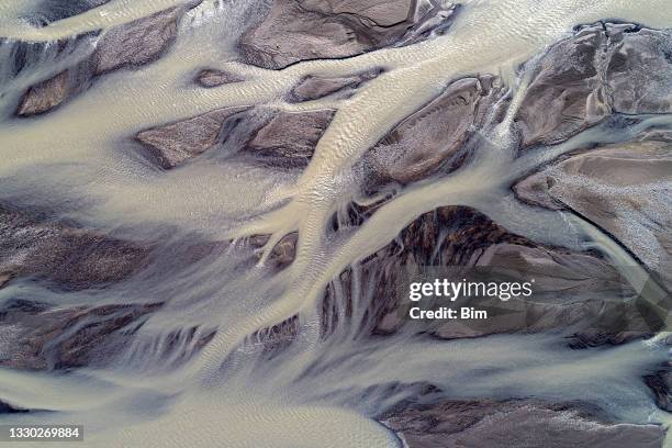 glacial river flows in iceland aerial view - braided river stock pictures, royalty-free photos & images