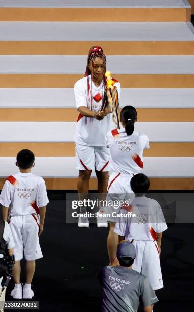 Tennis player Naomi Osaka is the final torchbearer to carry the flame, lighting the Olympic cauldron during the Opening Ceremony of the Tokyo 2020...