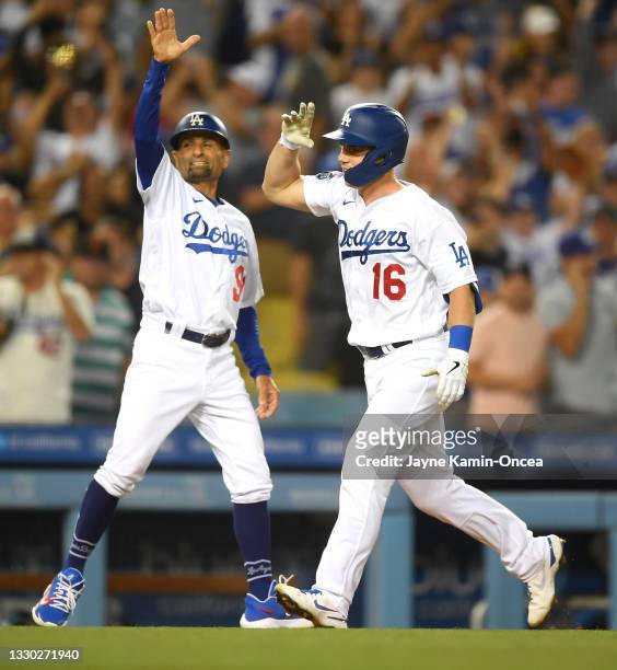 Will Smith of the Los Angeles Dodgers celebrates with third base coach Dino Ebel hitting a walk off three run home run in the ninth inning of the...