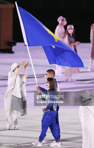 Flag bearers Majlinda Kelmendi and Akil Gjakova of Team Kosovo lead the team out during the Opening Ceremony of the Tokyo 2020 Olympic Games at...
