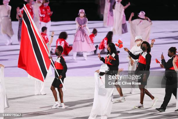 Flag bearer Kelly-Ann Baptiste of Team Trinidad and Tobago leads the team out during the Opening Ceremony of the Tokyo 2020 Olympic Games at Olympic...