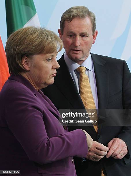 Irish Prime Minister Enda Kenny and German Chancellor Angela Merkel prepare to depart after speaking to the media following talks at the Chancellery...