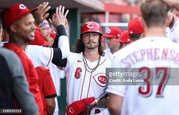 Jonathan India of the Cincinnati Reds is congratulated by teammates after scoring in the first inning against the St. Louis Cardinals at Great...