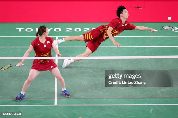 Watanabe Yuta and Higashino Arisa of Team Japan compete against Mathias Christiansen and Alexandra Boje of Team Denmark during a Mix Doubles Group C...