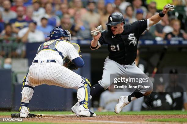 Zack Collins of the Chicago White Sox pulls up short at home plate before being tagged out running back to third base by Omar Narvaez of the...
