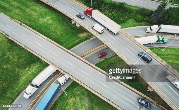 aerial view of semi trucks - autosnelweg stockfoto's en -beelden