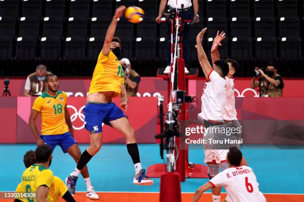 Lucas Saatkamp of Team Brazil attacks against Team Tunisia during the Men's Preliminary Round - Pool B on day one of the Tokyo 2020 Olympic Games at...