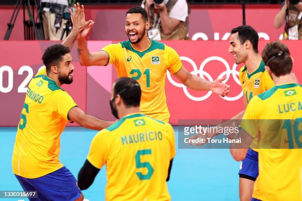 Alan Souza of Team Brazil celebrates with teammates after defeating Team Tunisia during the Men's Preliminary Round - Pool B on day one of the Tokyo...