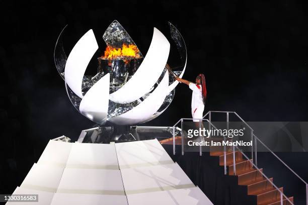 Naomi Oska lights the Olympic flame during the Opening Ceremony of the Tokyo 2020 Olympic Games at Olympic Stadium on July 23, 2021 in Tokyo, Japan.