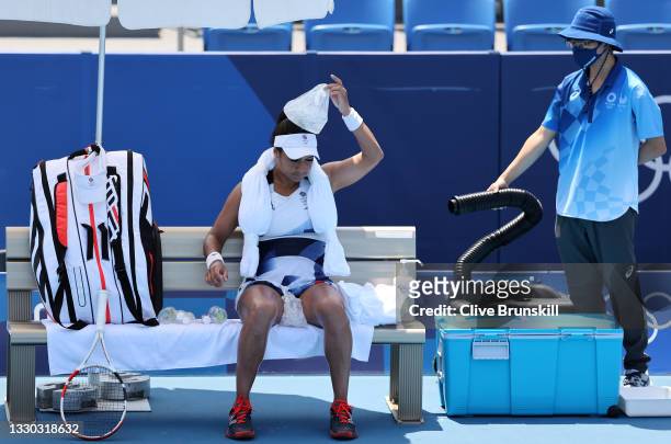 Heather Watson of Team Great Britain attempts to keep cool between games during her Women's Singles First Round match against Anna-Lena Friedsam of...