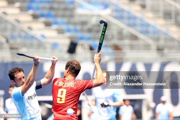 Pedro Ibarra of Team Argentina and Alvaro Iglesias Marcos of Team Spain battle for a loose ball during the Men's Pool A match on day one of the Tokyo...