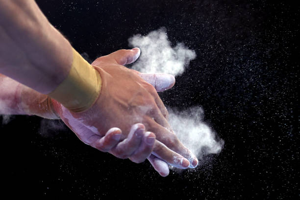 Detail of an athlete chalking their hands during Men's Qualification on day one of the Tokyo 2020 Olympic Games at Ariake Gymnastics Centre on July...