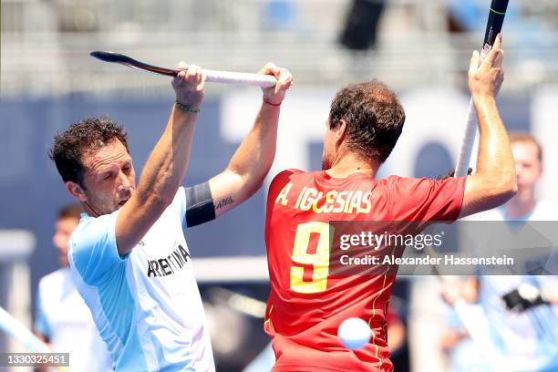 Pedro Ibarra of Team Argentina and Alvaro Iglesias Marcos of Team Spain battle for a loose ball during the Men's Pool A match on day one of the Tokyo...