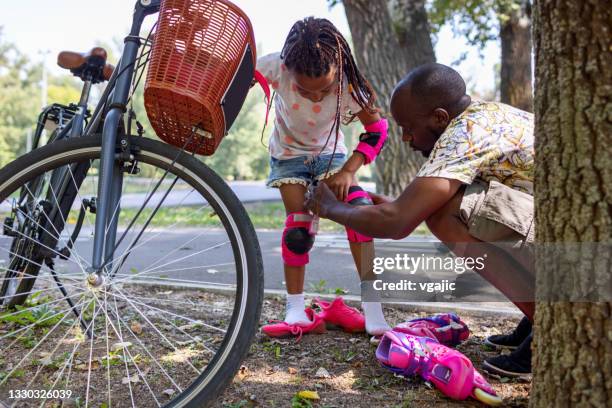 cute black girl learning to skate - kneepad stock pictures, royalty-free photos & images