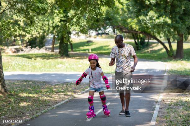 first steps on roller skates with father - 6 steps imagens e fotografias de stock