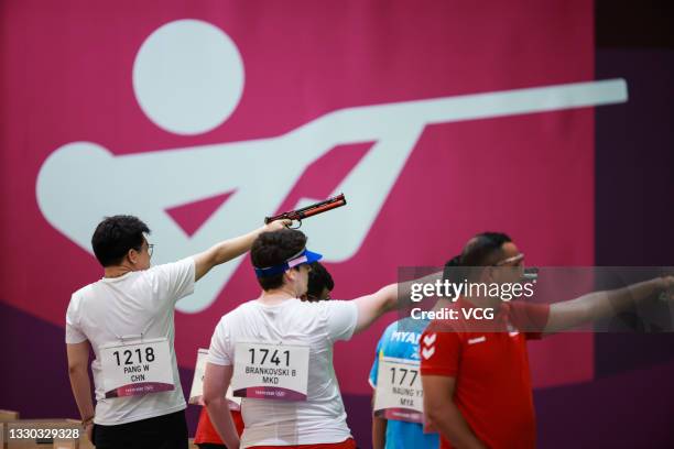 Athletes in action during the 10m Air Pistol Men's Qualification on the first day of the Tokyo 2020 Olympic Games at the Asaka Shooting Range on July...