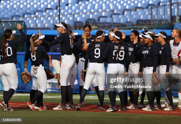 Pitcher Monica Abbott of Team United States and teammates high five after their 2-0 win against Team Mexico during the Softball Opening Round on day...