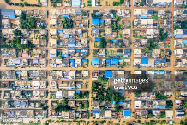 Aerial view of floodwater submerging Peng Village after the bank of Weihe River has been destroyed in the downpour on July 23, 2021 in Hebi, Henan...