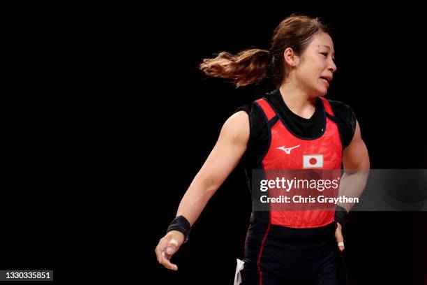 Hiromi Miyake of Team Japan competes during the Weightlifting - Women's 49kg Group A on day one of the Tokyo 2020 Olympic Games at Tokyo...