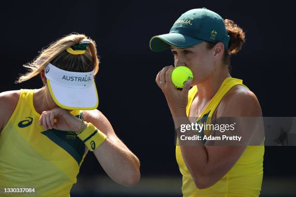 Ashleigh Barty of Team Australia talks with partner Storm Sanders of Team Australia during their Women's Doubles First Round match against Nao Hibino...