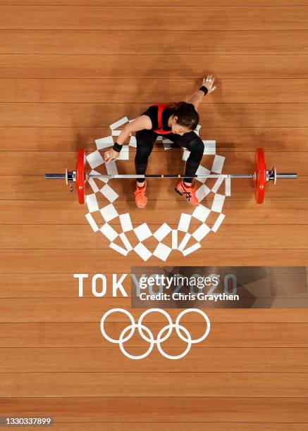 Hiromi Miyake of Team Japan competes during the Weightlifting - Women's 49kg Group A on day one of the Tokyo 2020 Olympic Games at Tokyo...